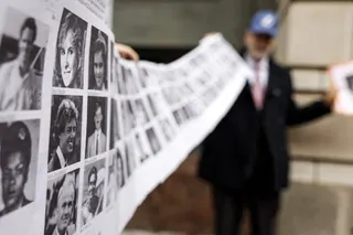 Paul Hudson, whose daughter Melina was one of the victims in the Pan Am Flight 103 Lockerbie bombing, holds up a banner of pictures of additional victims outside the federal court before the trial of a Libyan man accused of making the bomb that destroyed the plane on December 12, 2022 in Washington, DC. U.S. officials announced that they had arrested Abu Agila Mohammad Mas’ud Kheir Al-Marimi for his involvement in the bombing that killed 270 people. — Getty Images via AFP