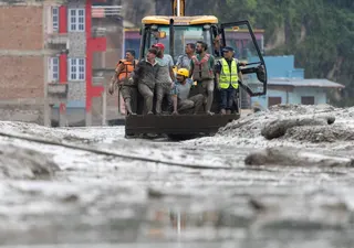 Rescuers riding in an excavator at Devighat village, following a flash flood in Trishuli Bazar, in Nepal’s Nuwakot district, on Aug 26.