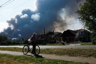 A resident walks near houses damaged during a Russian drone strike in Ukraine’s Kyiv region on Thursday. Photo: Reuters