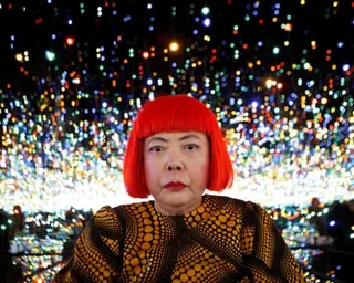 Japanese artist Yayoi Kusama poses inside her Infinity Mirrored Room installation in 2013.
