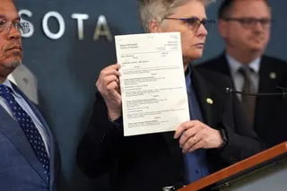 a woman holds a sheet of paper