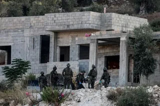 Israeli soldiers remove the body of a killed Palestinian from a house under construction, on the western outskirts of the northern city of Jenin, in the Israeli-occupied West Bank on August 28, 2026.