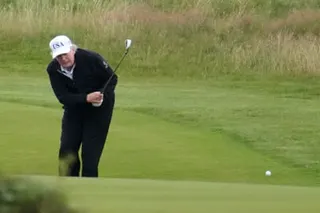 Donald Trump plays a shot on a golf course
