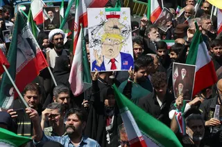 A woman holds up a poster mocking US President Donald Trump while others carry portraits of Iran’s slain supreme leader Ayatollah Ali Khamenei and his son, Mojtaba Khamenei, during a rally in Tehran on April 9. Photo: AFP