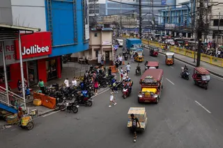 A jeepney drives past a Jollibee at Divisoria in Manila, Philippines. Photo: Reuters