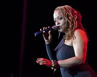 a woman sings into a microphone