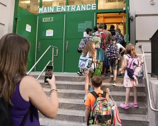 students walk into school on the first day of classes