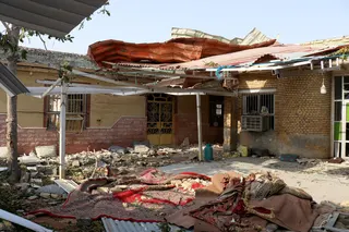 Rubble lies around the damaged house. Photo: West Asia News Agency via Reuters