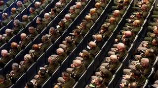 Members of the military attend a meeting