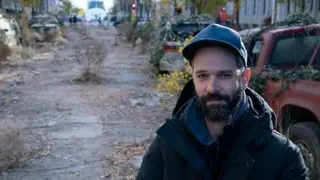 a man, Neil Druckmann, standing in the middle of an empty road on the set of HBO’s The Last of Us The Last of Us Season 1 - Episode 2 The Last of Us season 1, episode 2.