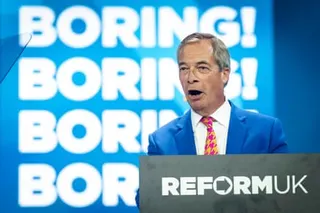 Nigel Farage on stage in front of a sign that says ‘Boring! Boring!’
