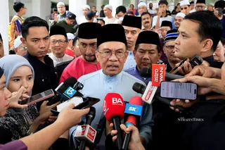Prime Minister Datuk Seri Anwar Ibrahim speaking to reporters after performing Friday prayers at Masjid Bukit Indah. NSTP/AIZUDDIN SAAD