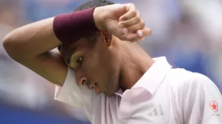 Felix Auger-Aliassime wipes his brow during his US Open defeat by Karen Khachanov