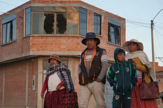 People walk near a military barracks following an explosion that has so far left 10 dead and 62 injured, in Viacha, Bolivia, on Friday. Photo: EPA