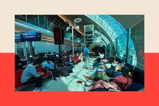 An airport terminal full of people waiting