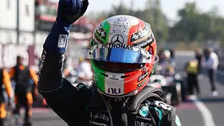 Kimi Antonelli clenches his right fist in celebration after getting out of his car following his win in the Italian Grand Prix
