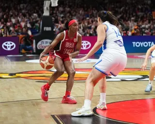 Jackie Young of USA dribbles while guarded by an Italy defender during a game