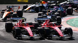 The Ferraris of Charles Leclerc and Lewis Hamilton side by side into the first chicane at the start of the Italian Grand Prix