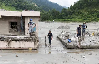 Nepal police personnel comb Betrawati, Nuwakot district, for survivors and victims on Sunday. Photo: Reuters